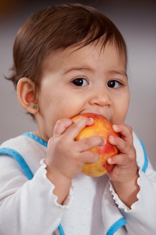 Child eating peach