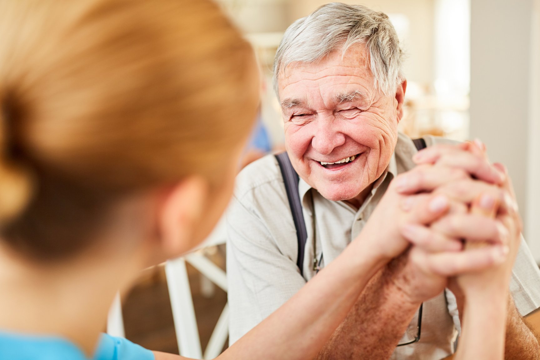 Old Man Happily Talking to Nurse